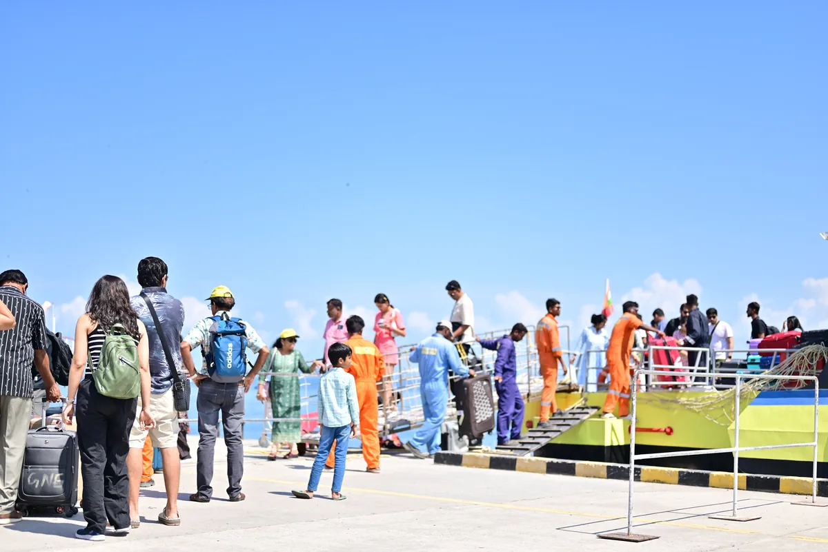 Boarding at Haddo Jetty — ground crew help with luggage before the gangway Passengers queuing to board a Makruzz ferry at Haddo Jetty