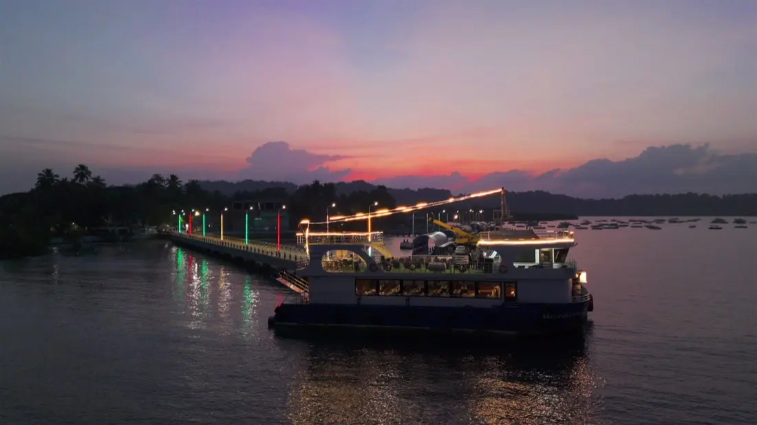 The cruise lit up at dusk beside the jetty